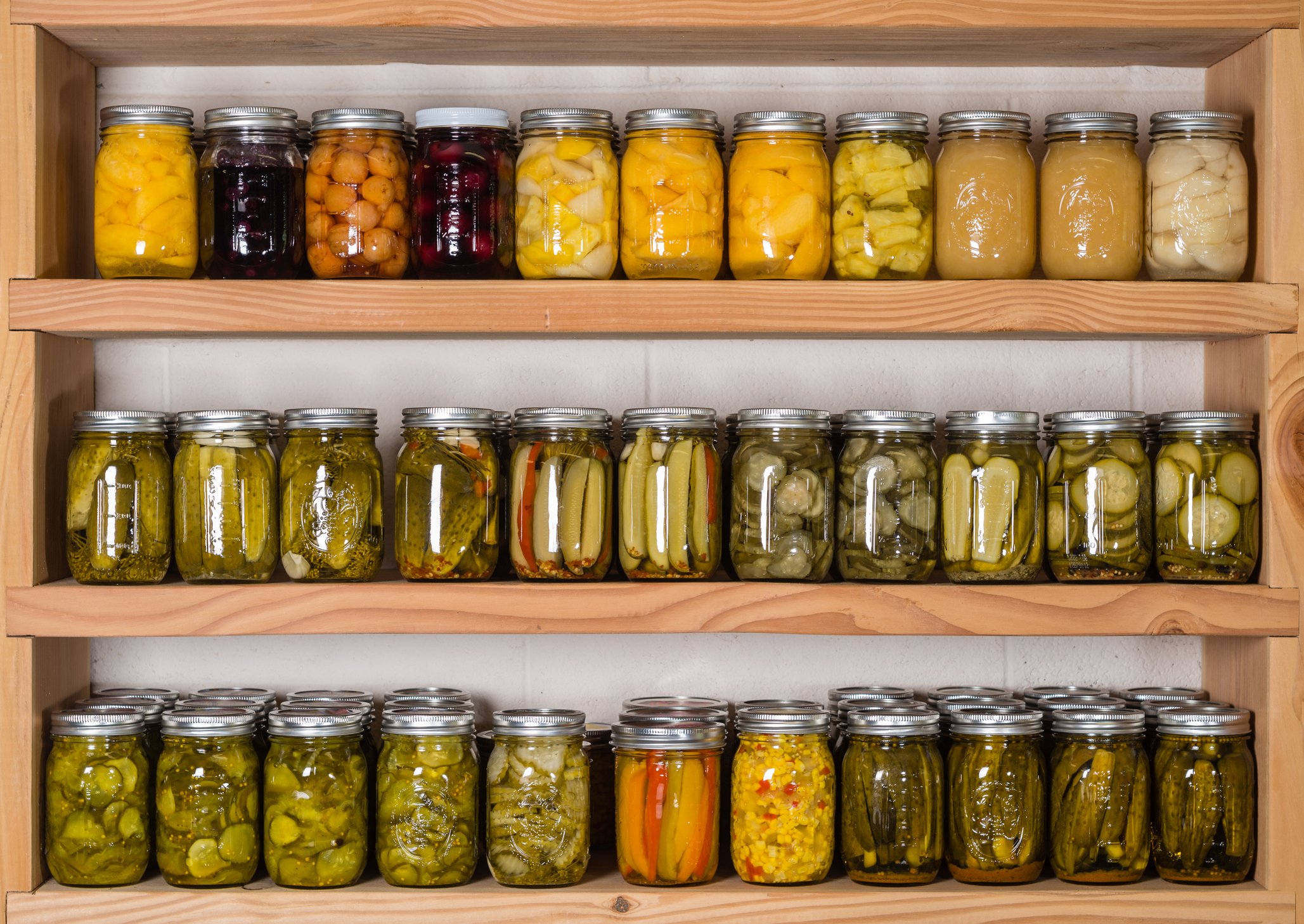 Jars of food on pantry shelves.