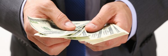 banker handing out cash representing loan