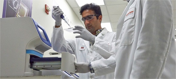 Lab workers performing a test