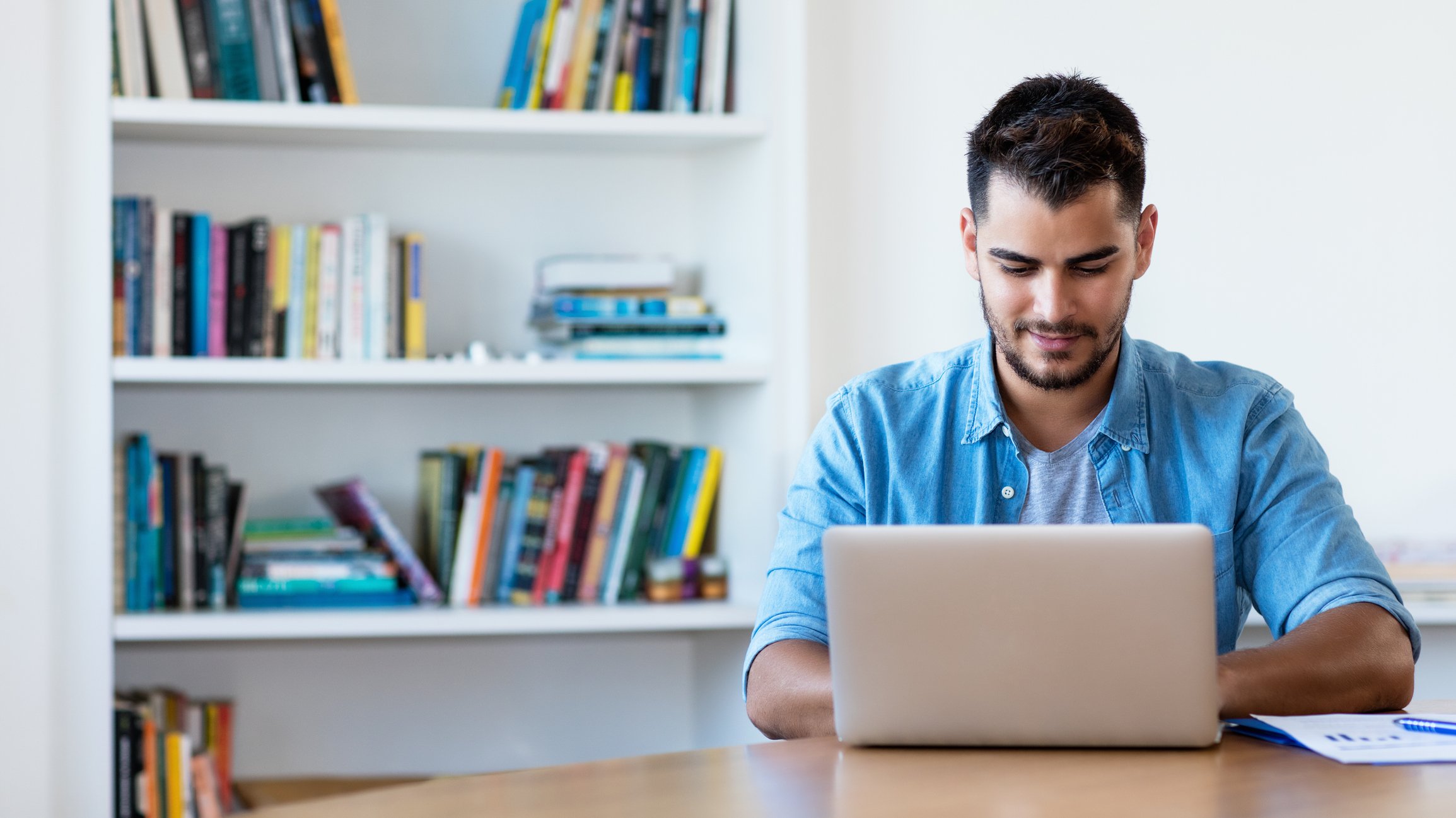 Man typing on computer at home