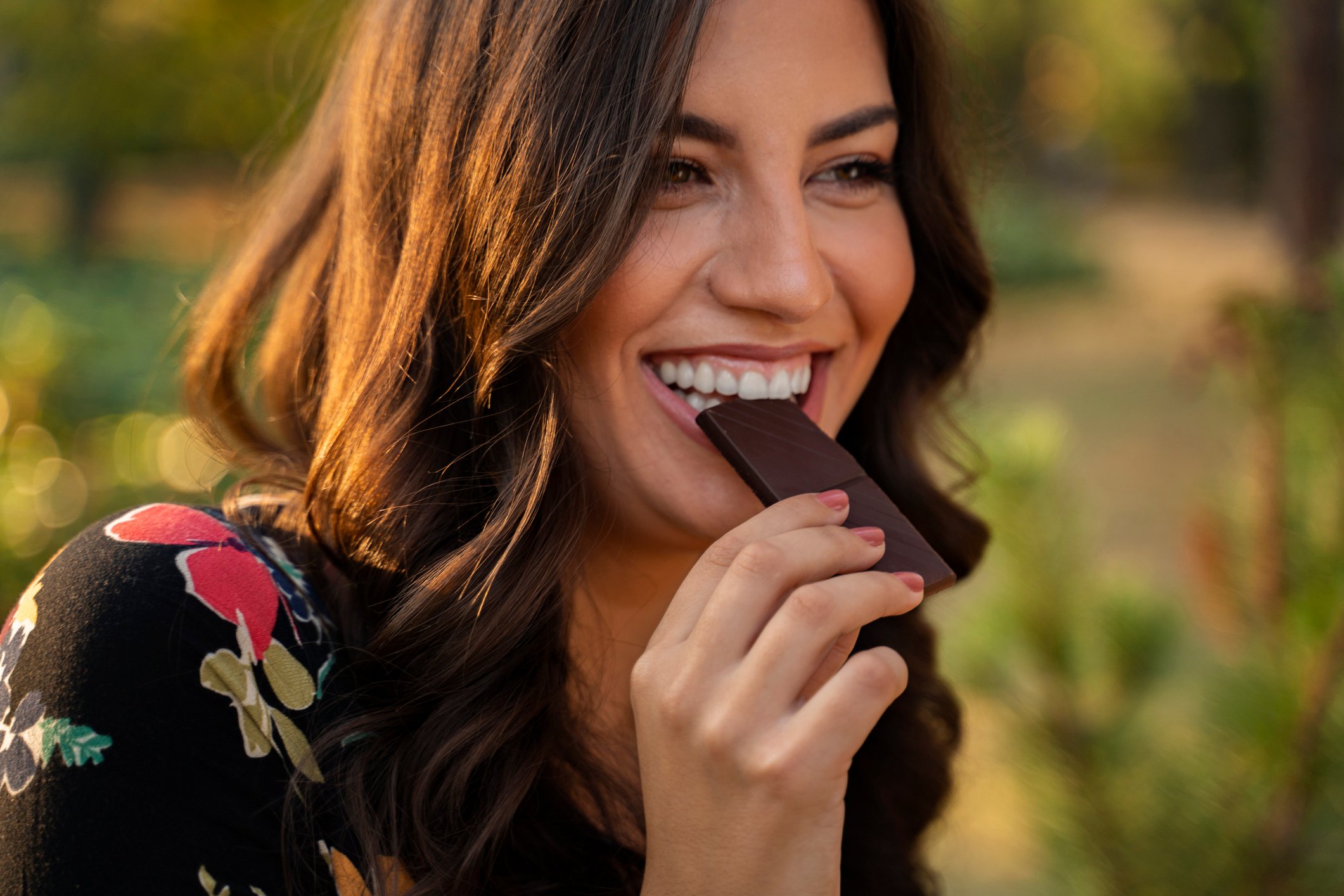 A woman enjoying a candy bar.