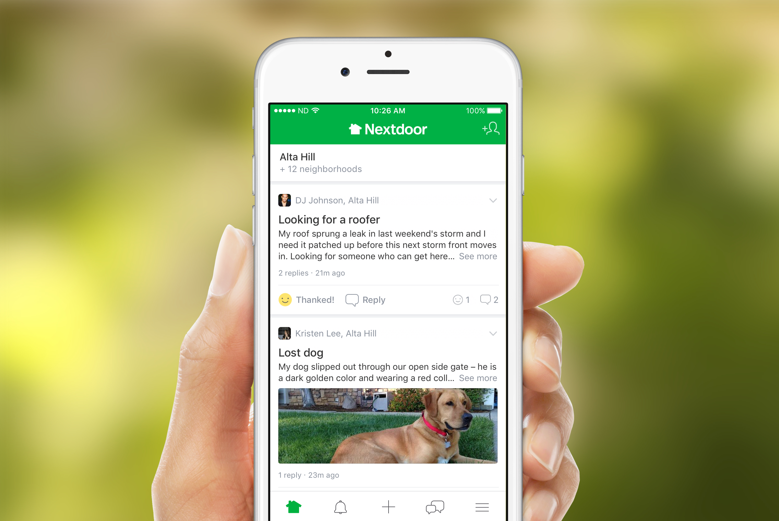 A hand holding the home screen for the Nextdoor app.