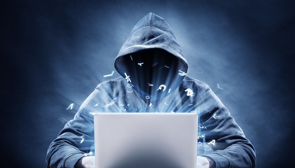 Hooded hacker at a laptop