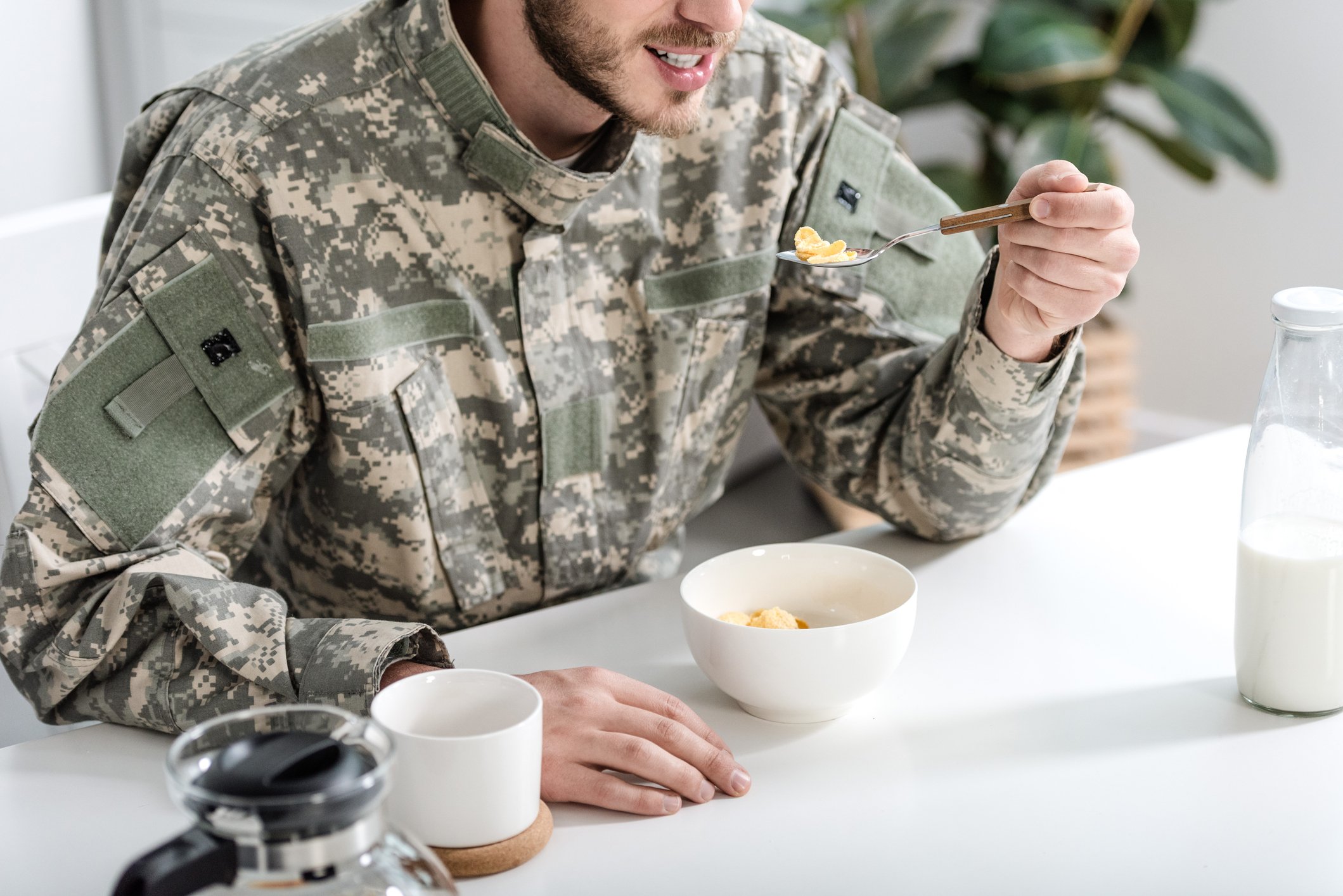 Soldier in camouflage eating breakfast