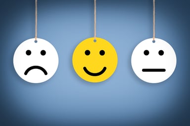 Smiley face in between two other faces