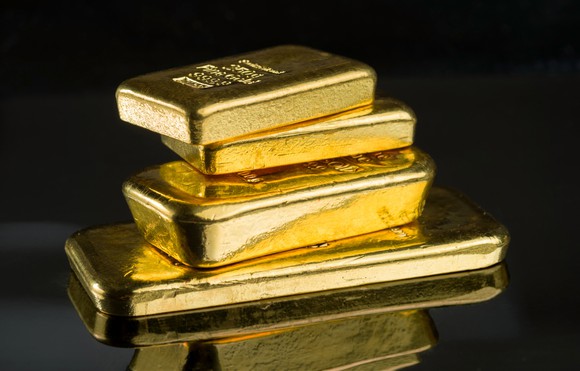 Four gold bars stacked on top of each other.