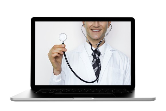 Laptop screen showing a smiling physician holding a stethoscope 