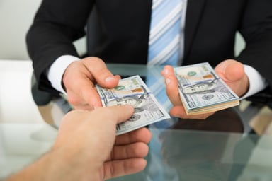 Businessman Handing Over Money