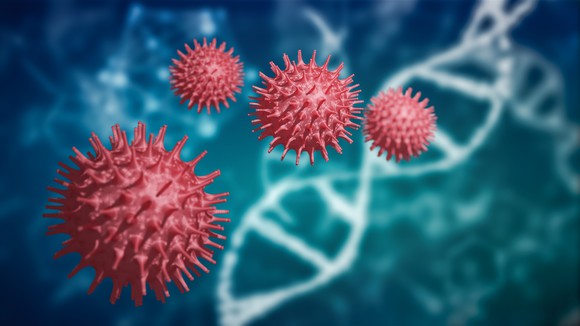 Four coronavirus particles with a double helix in the background