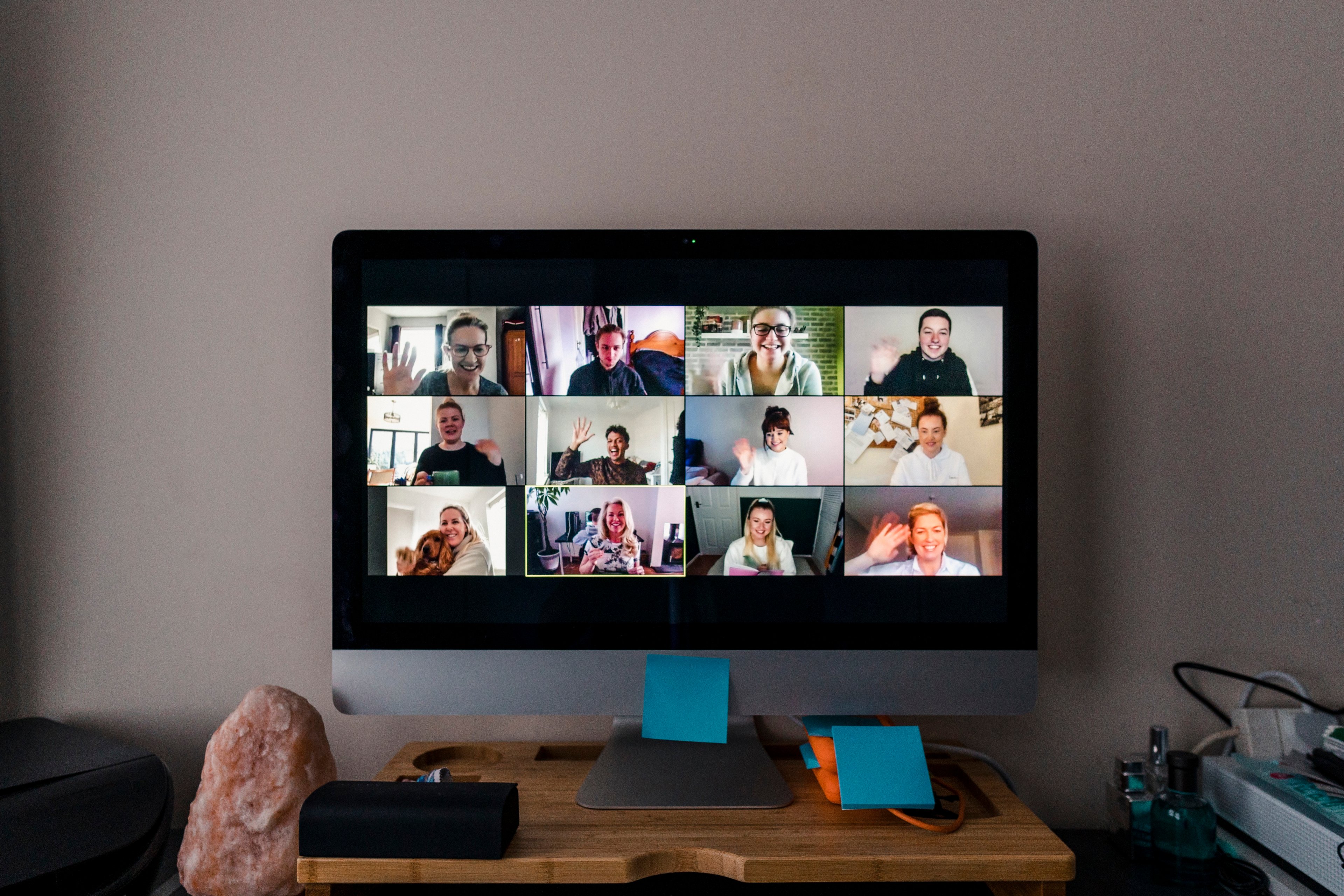 A video conference taking place on a computer with multiple people on the screen. 