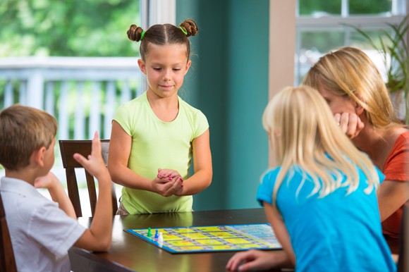 A family plays a board game.