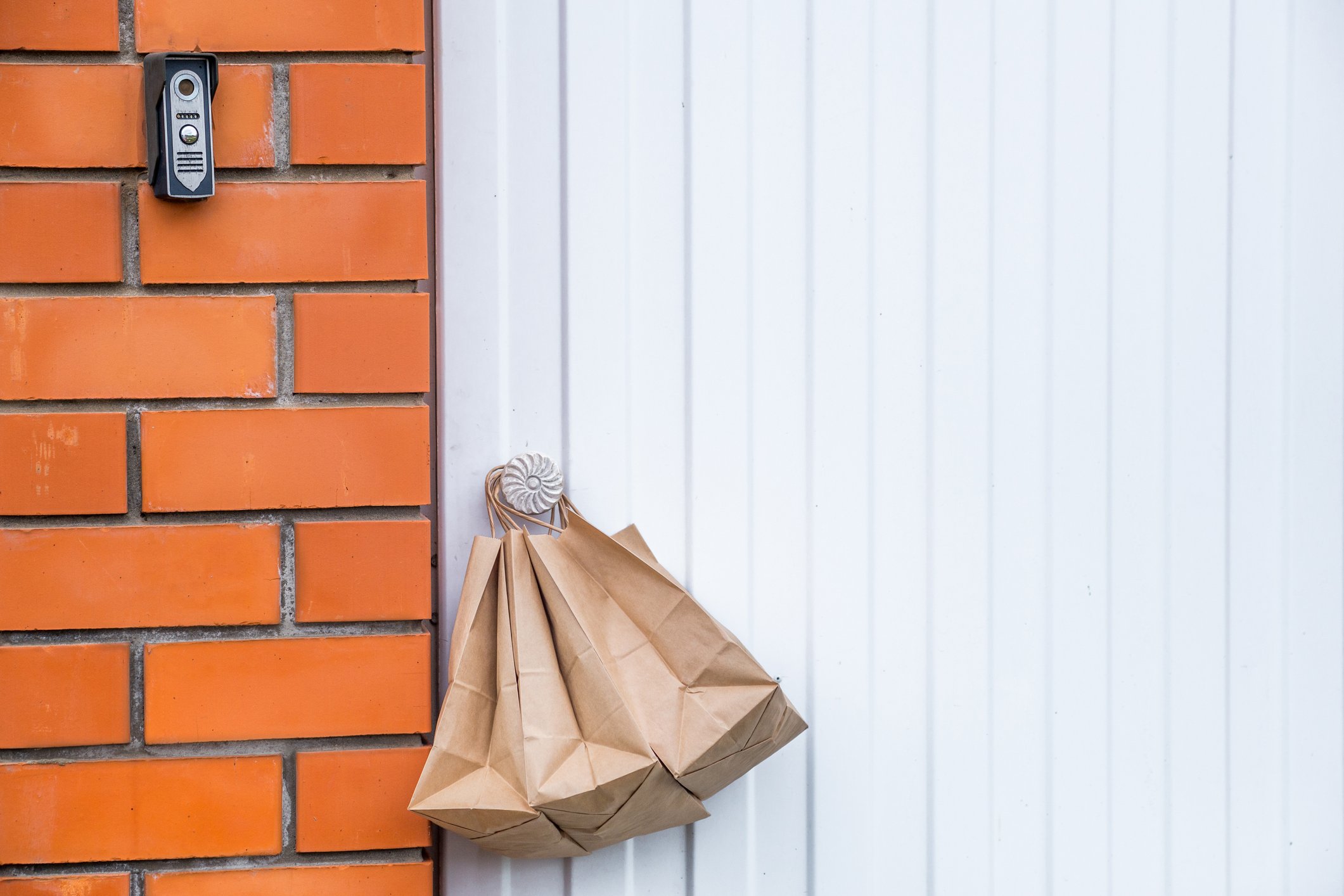 Paper delivery bags hanging on a doorknob.