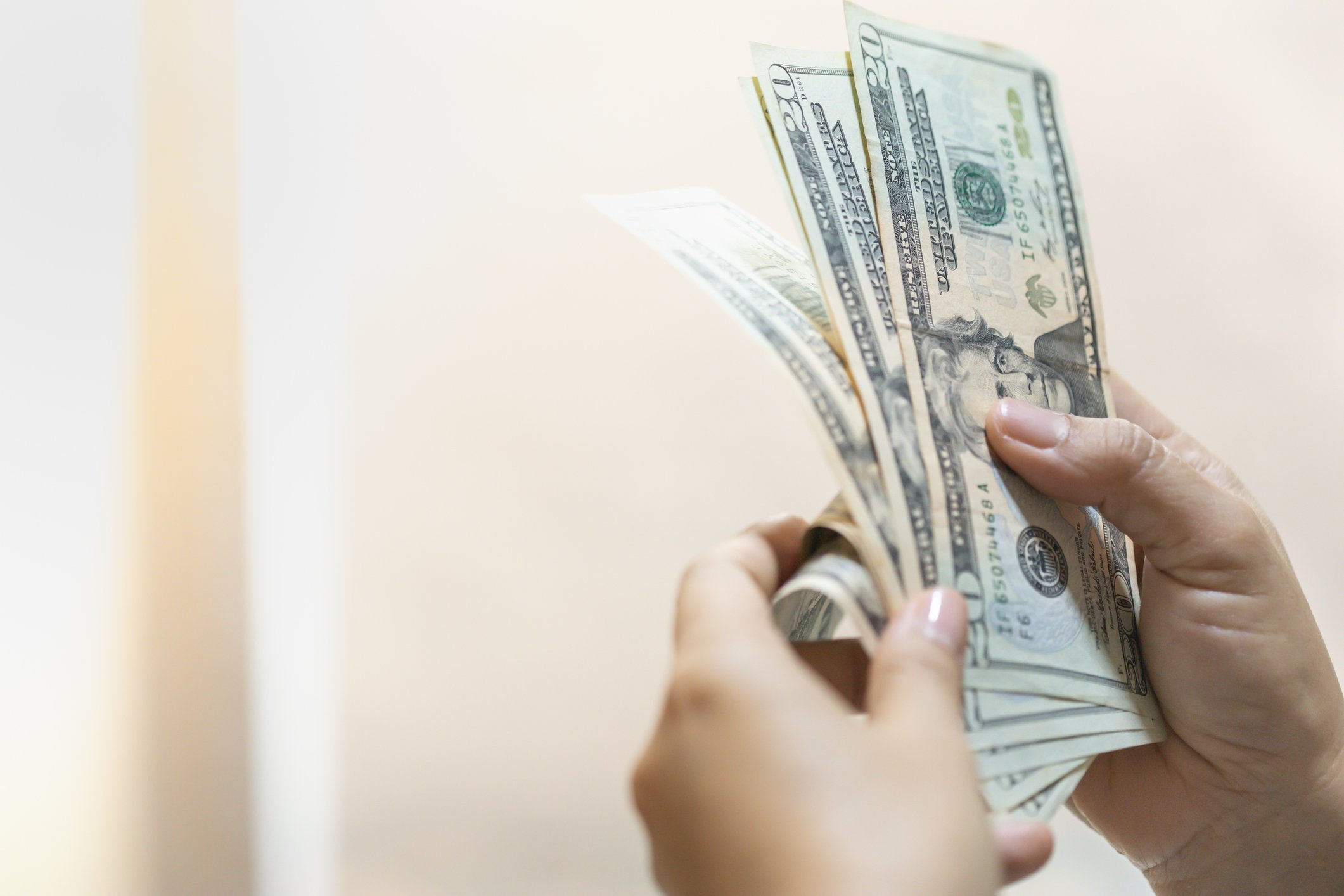 A woman counting a cash bonus.