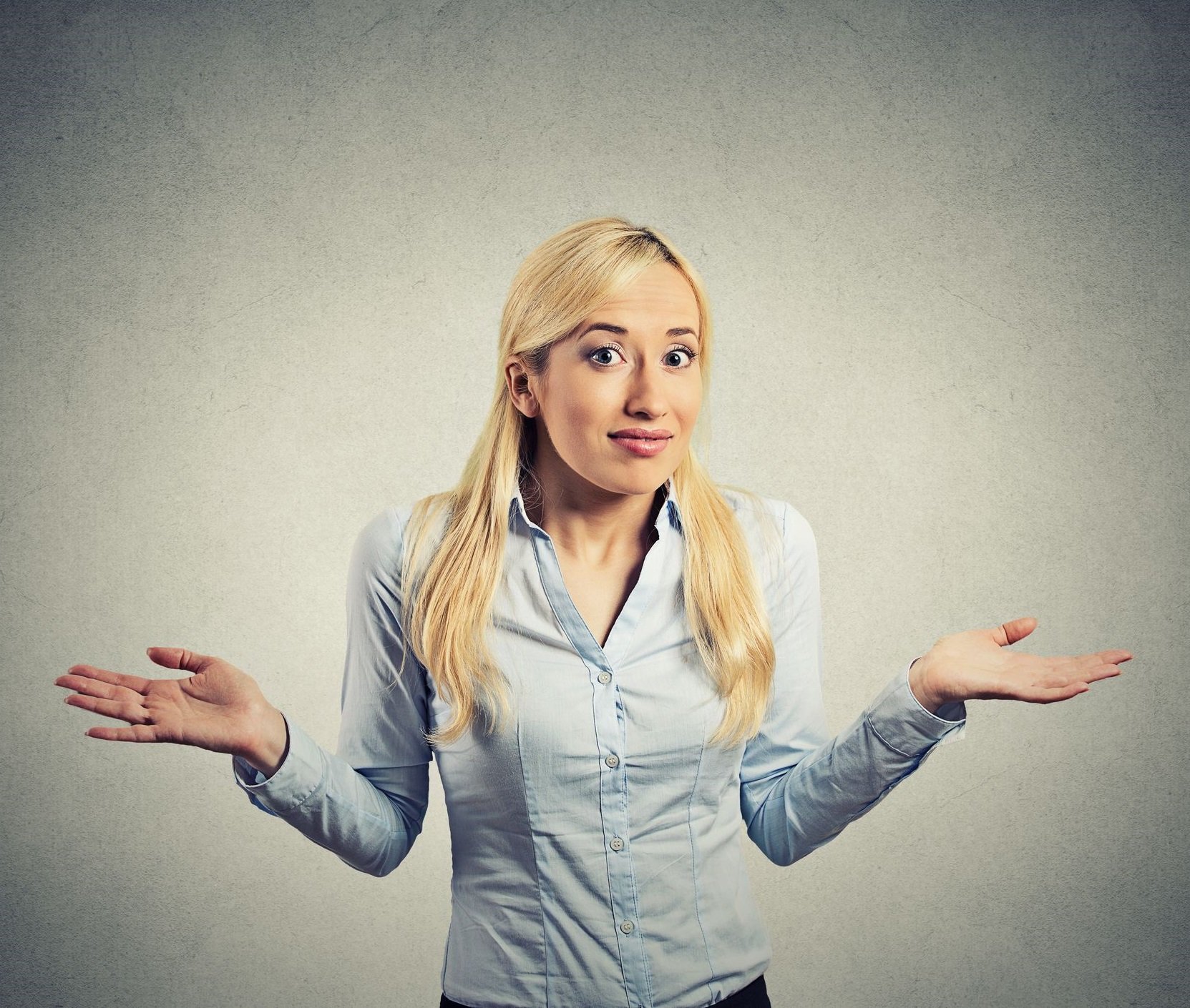 A woman shrugs in uncertainty.