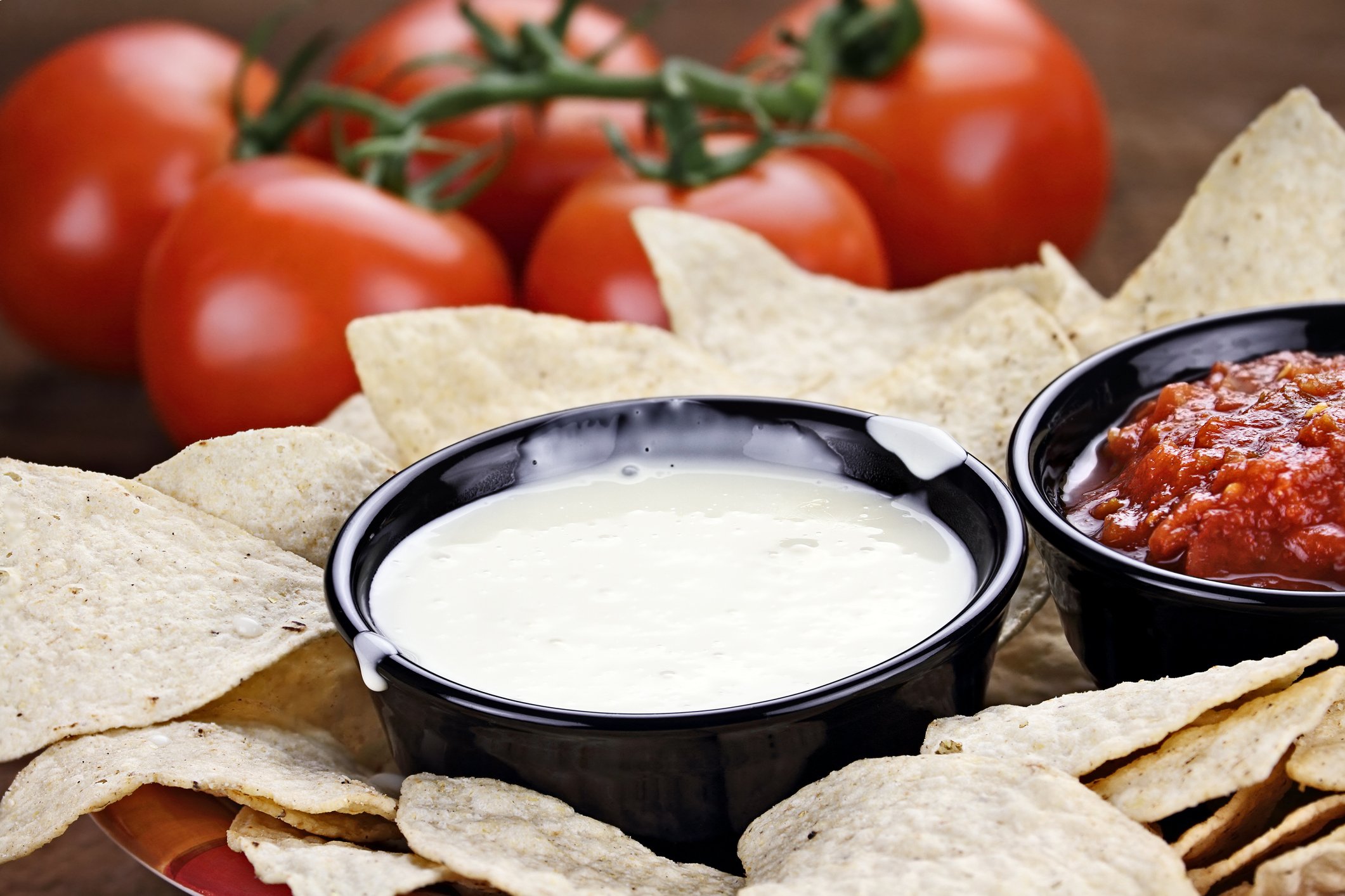A bowl of generic queso blanco dip with tortilla chips.