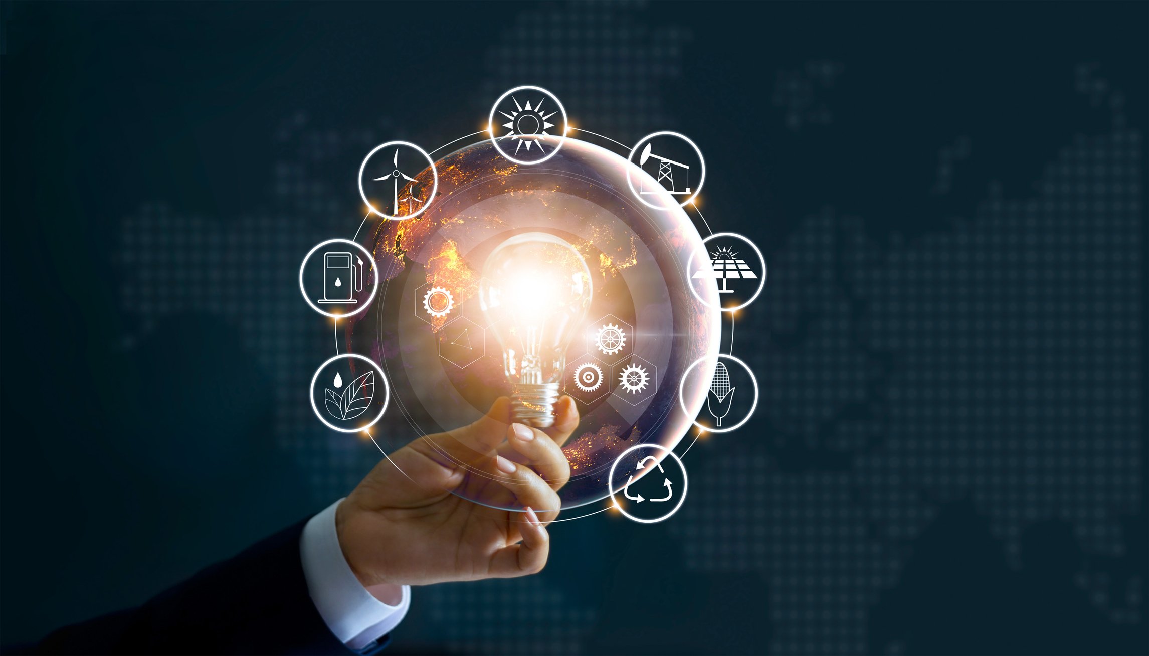 A hand holds a lit light bulb surrounded by icons of different energy types.