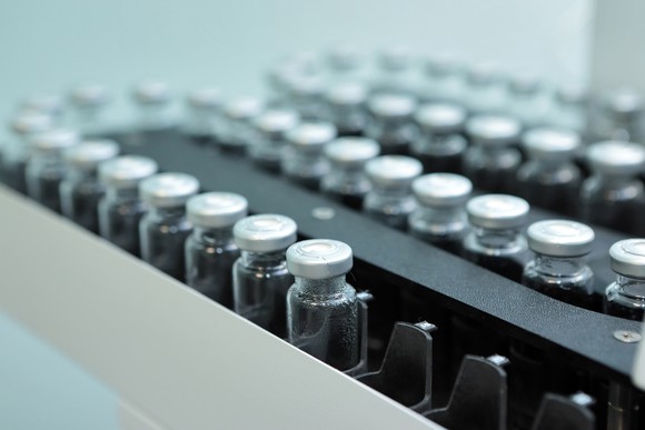 Vials of drugs on a manufacturing line