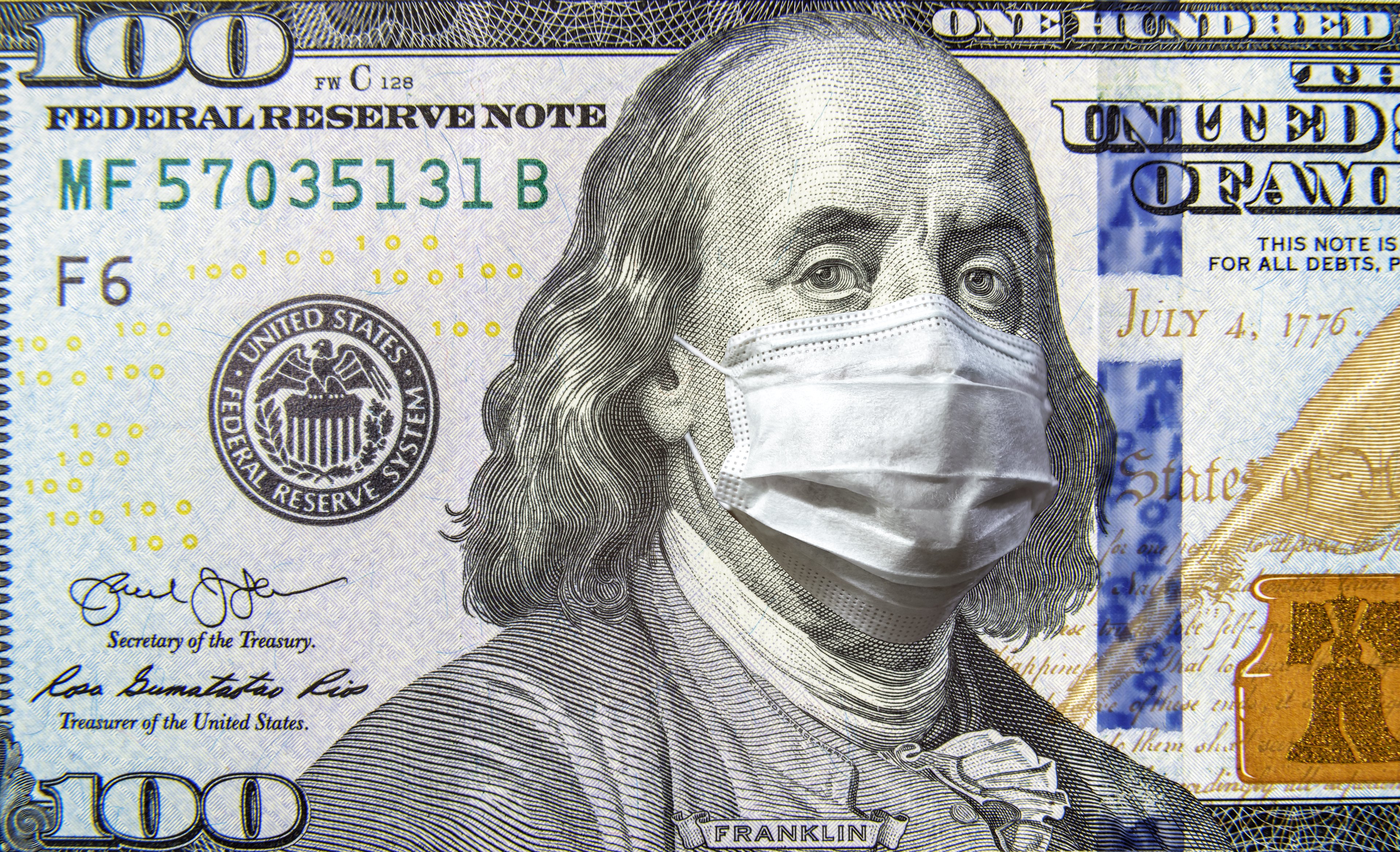 A $100 bill with Benjamin Franklin wearing a surgical mask
