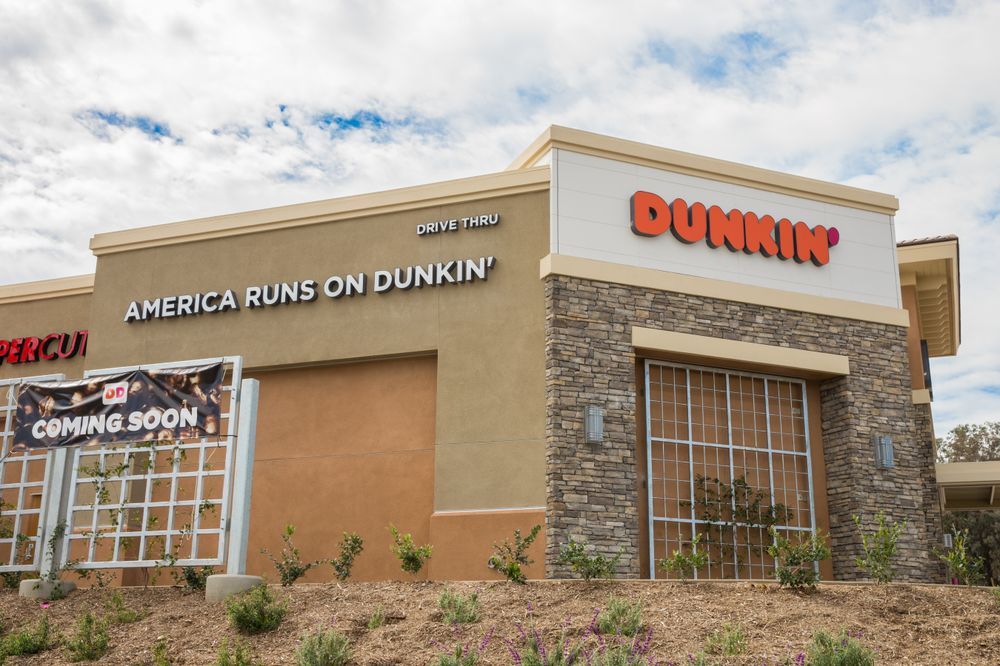 A Dunkin' outlet with an "America Runs on Dunkin'" sign.
