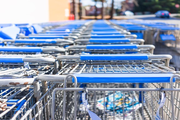 Rows of shopping carts are lined up outside a Walmart