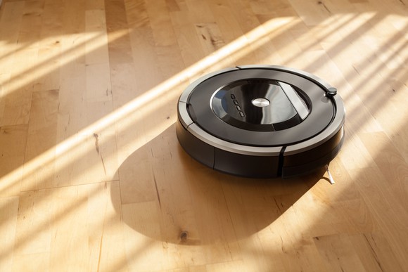 A robotic vacuum cleaner on a hardwood floor