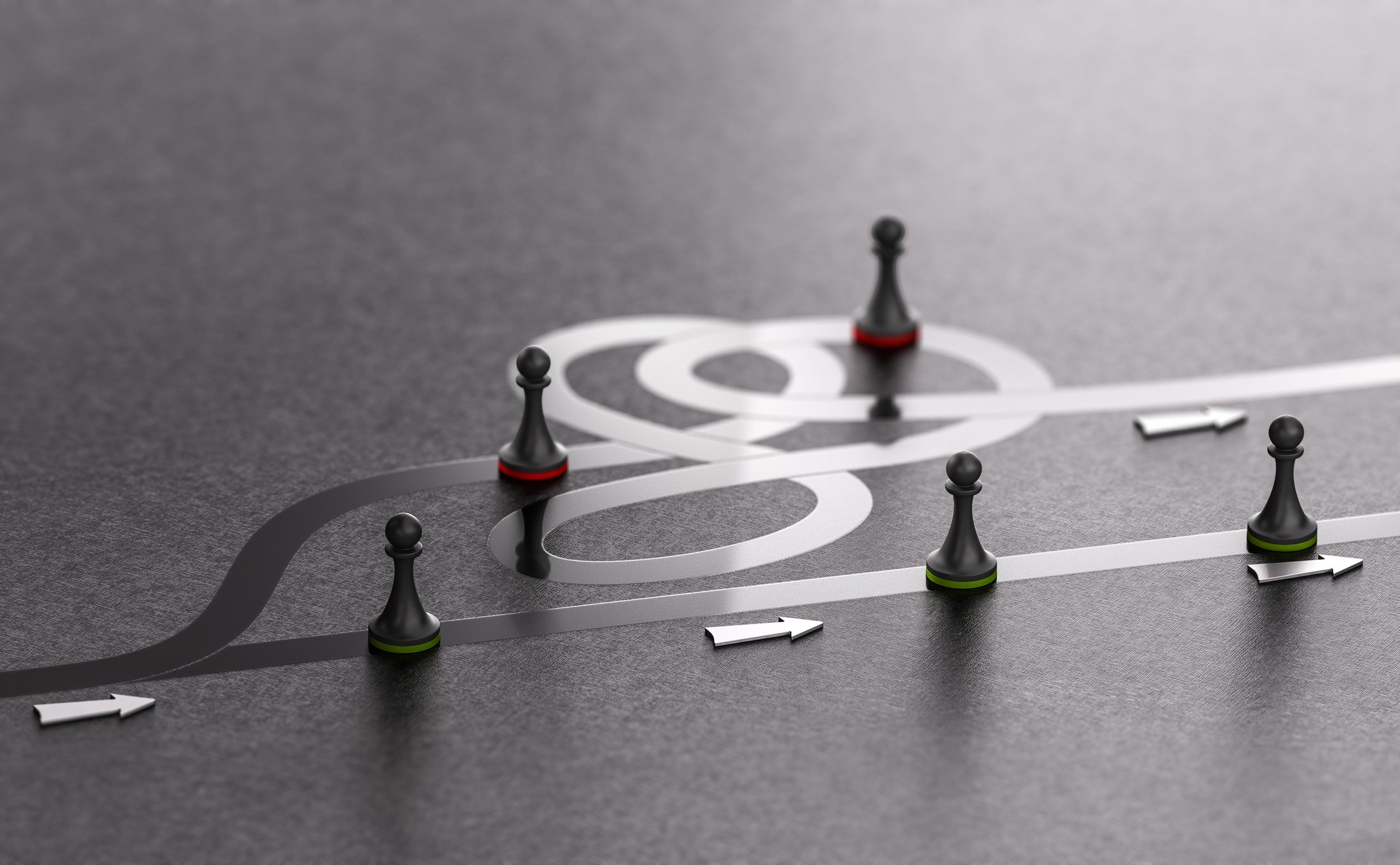 Game pieces on a complicated and a simple game board path.