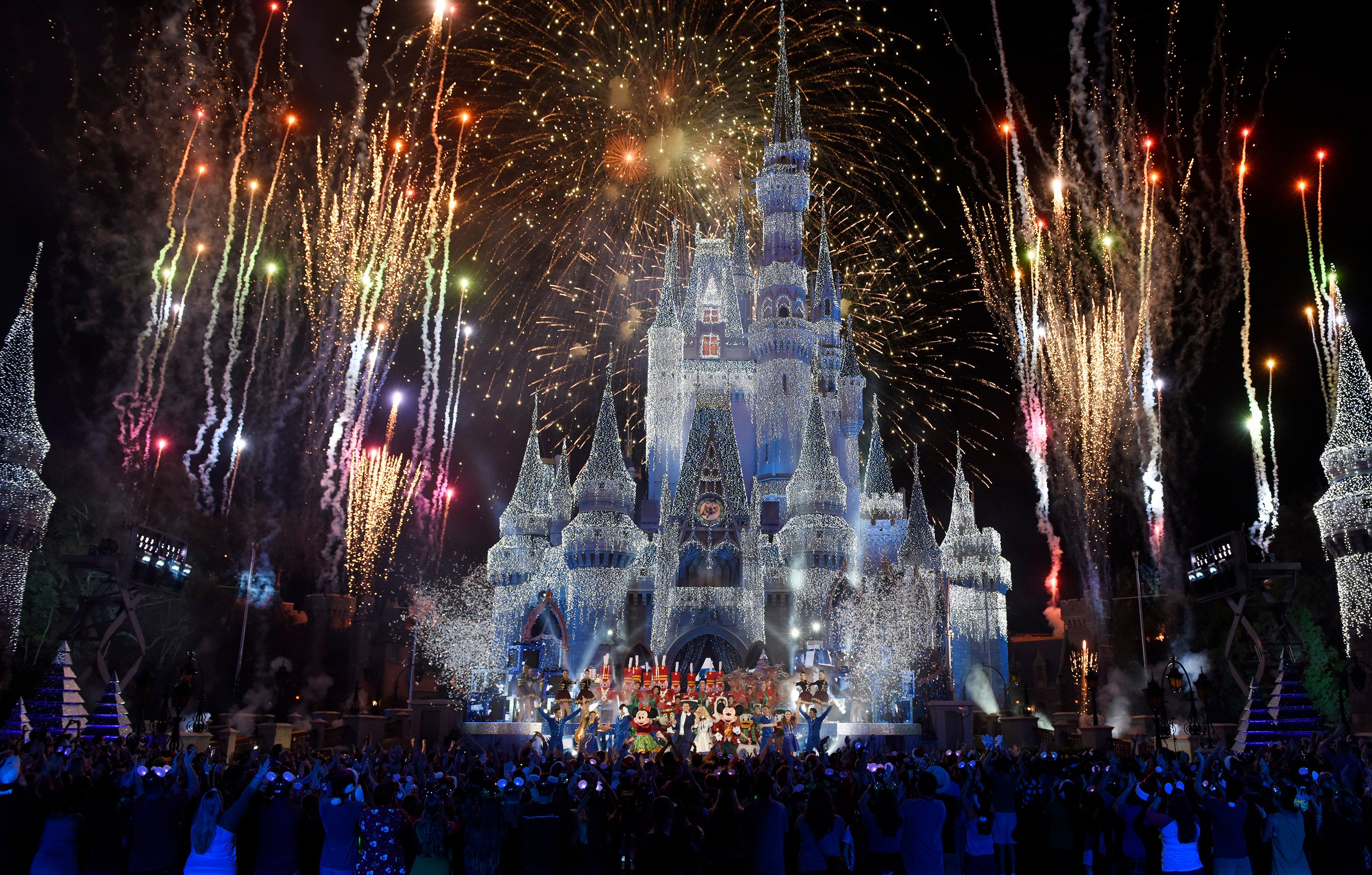 The Disney castle at night during a fireworks display.