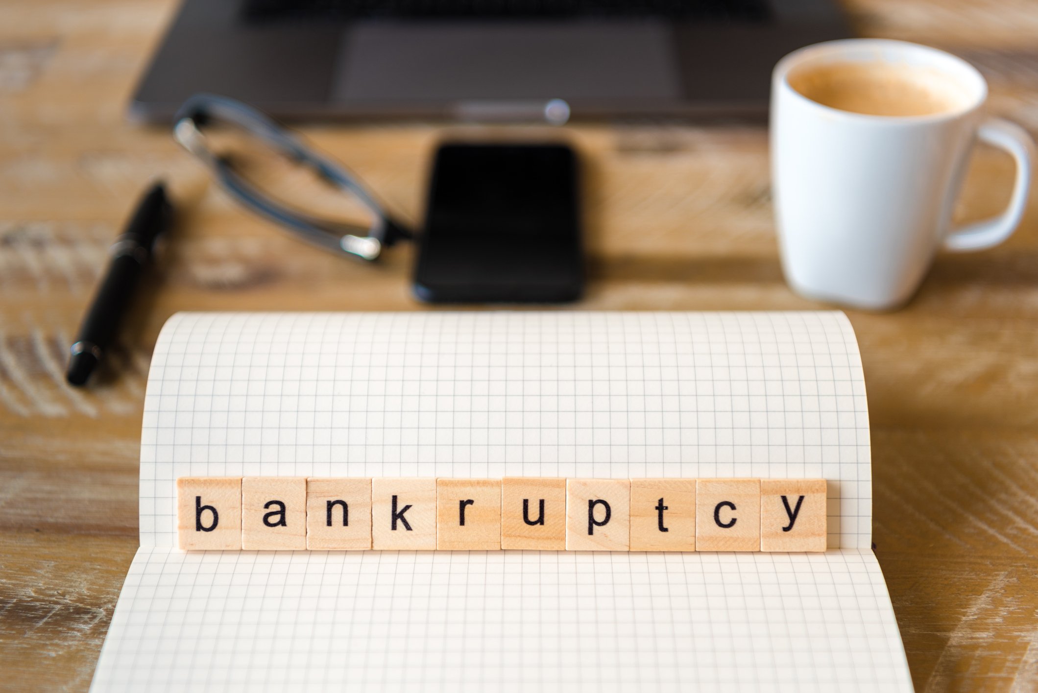 Wood squares are laid out to spell bankruptcy.
