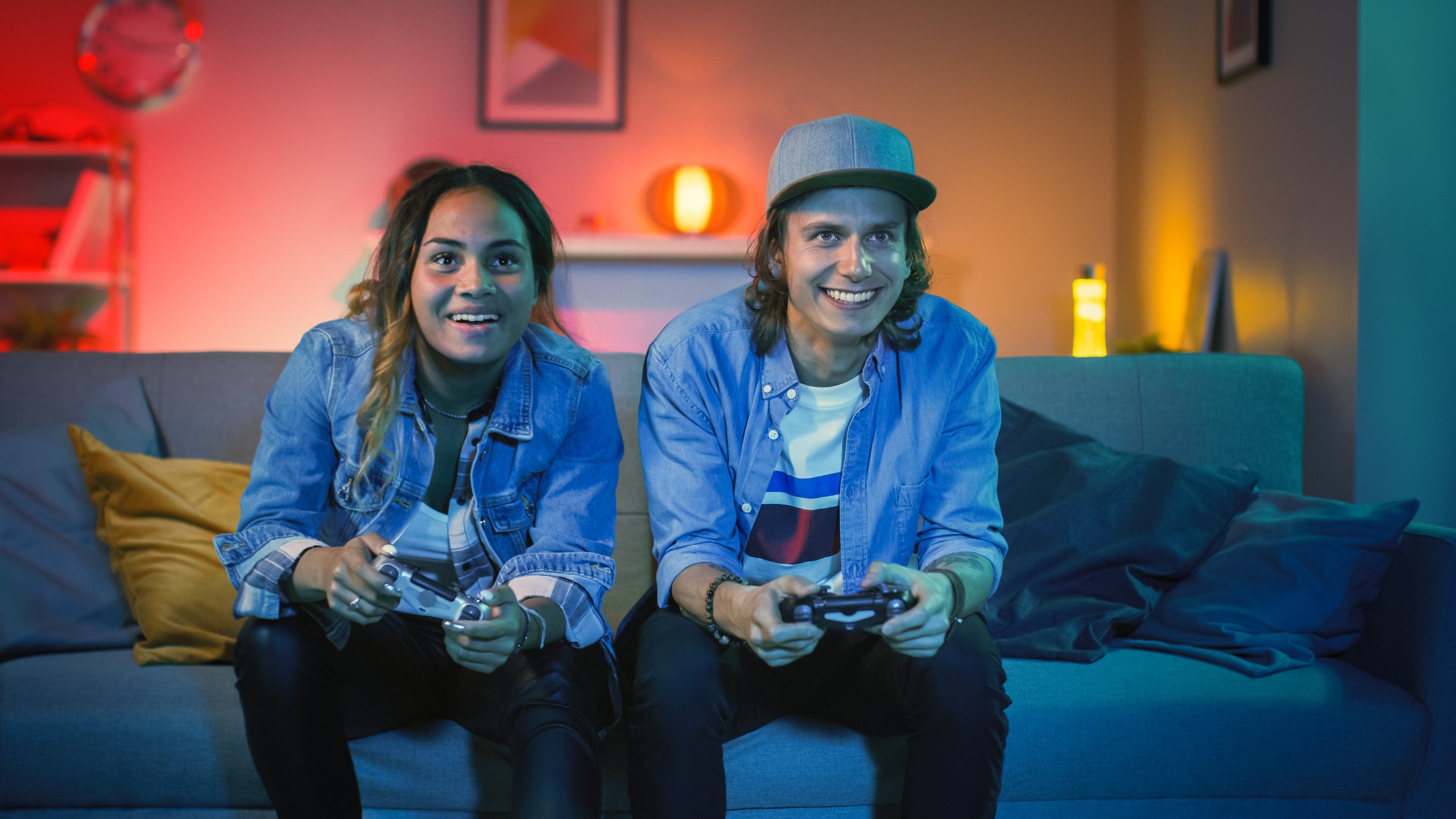 A young couple plays video games together.