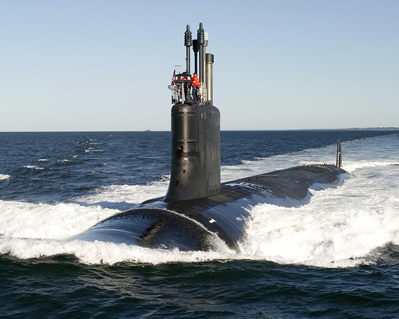A submarine riding on top of the waves.