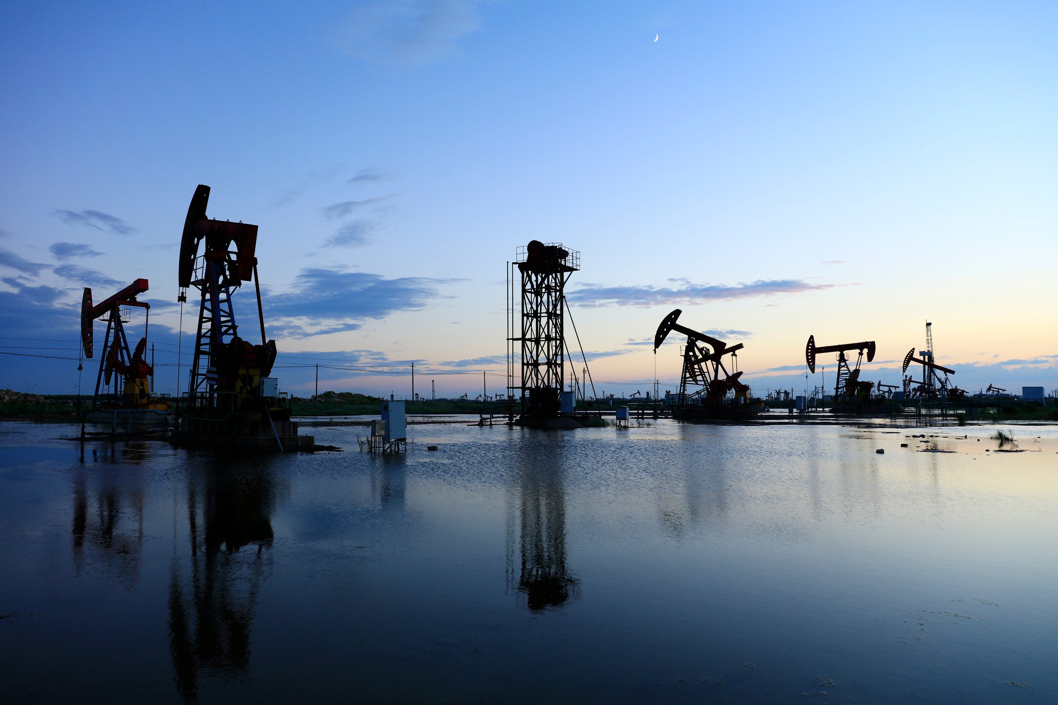 Pumpjacks at twilight in an oilfield.