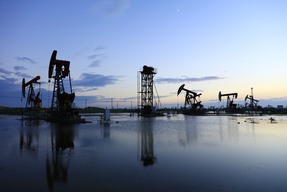 Pumpjacks at twilight in an oilfield.