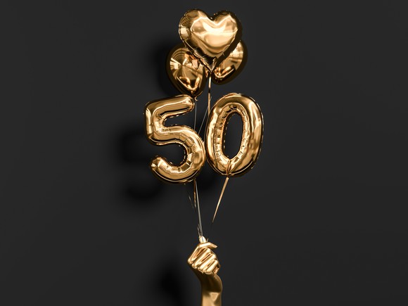 A golden hand holds up numbered "50" balloons with hearts.