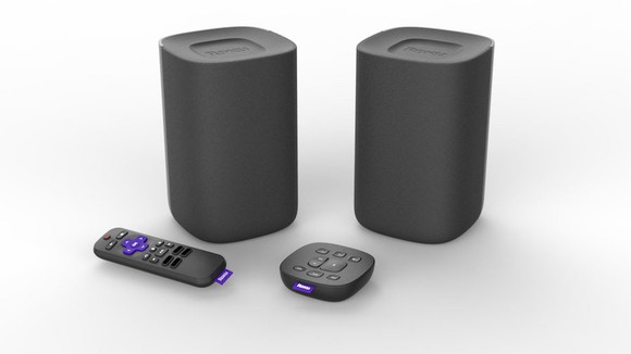 A Roku streaming device with remote control and speakers