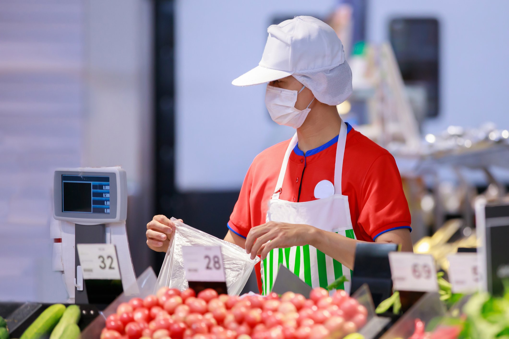 A supermarket worker in a mask.