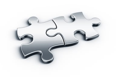 Two metal jigsaw pieces connected