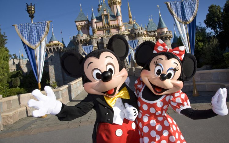 Mickey and Minnie Mouse welcoming guests to Disneyland