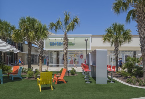 Outdoor area of a Tanger outlet mall.