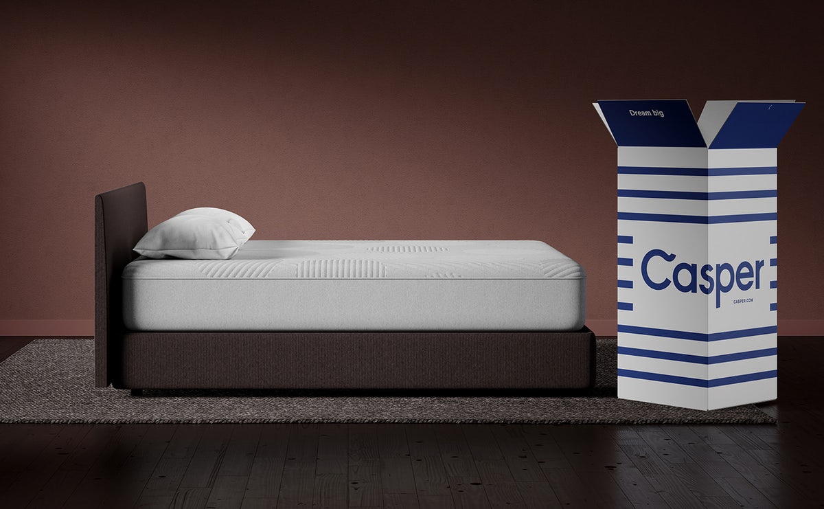A bed next to a Casper box
