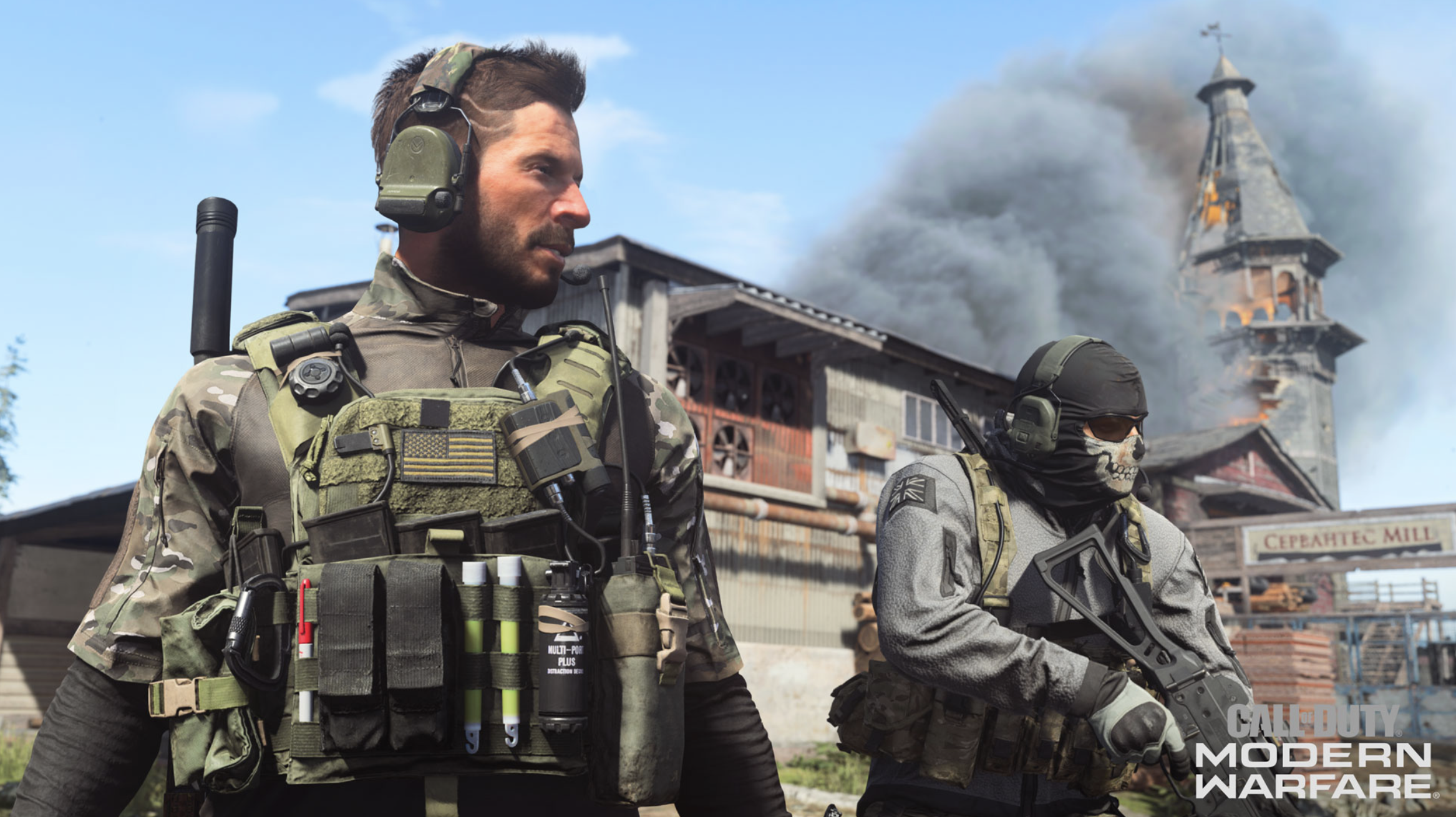 A screenshot of Call of Duty Modern Warfare showing two soldiers standing in an industrial area with a building on fire in the background.