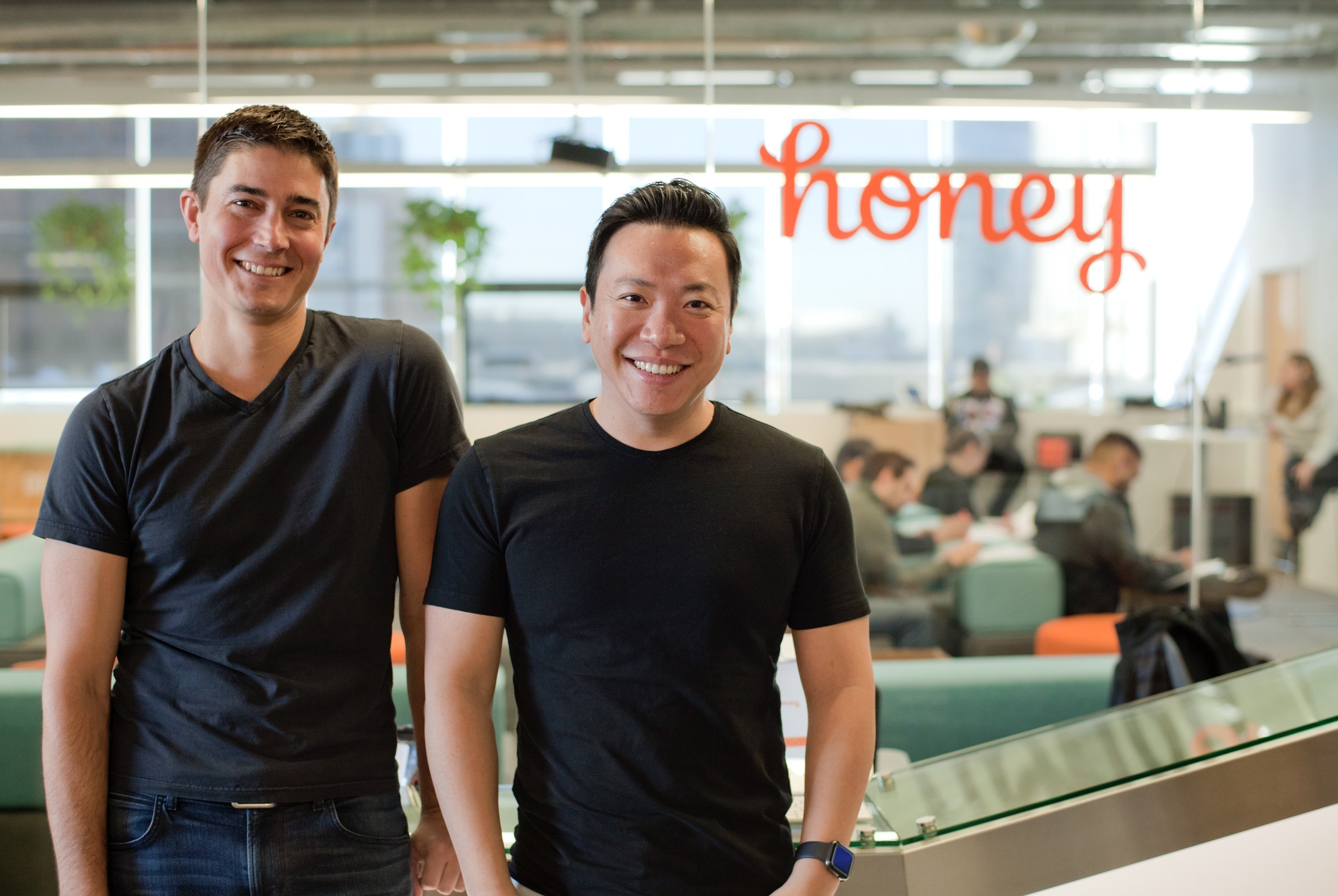 The two founders of Honey standing in their office