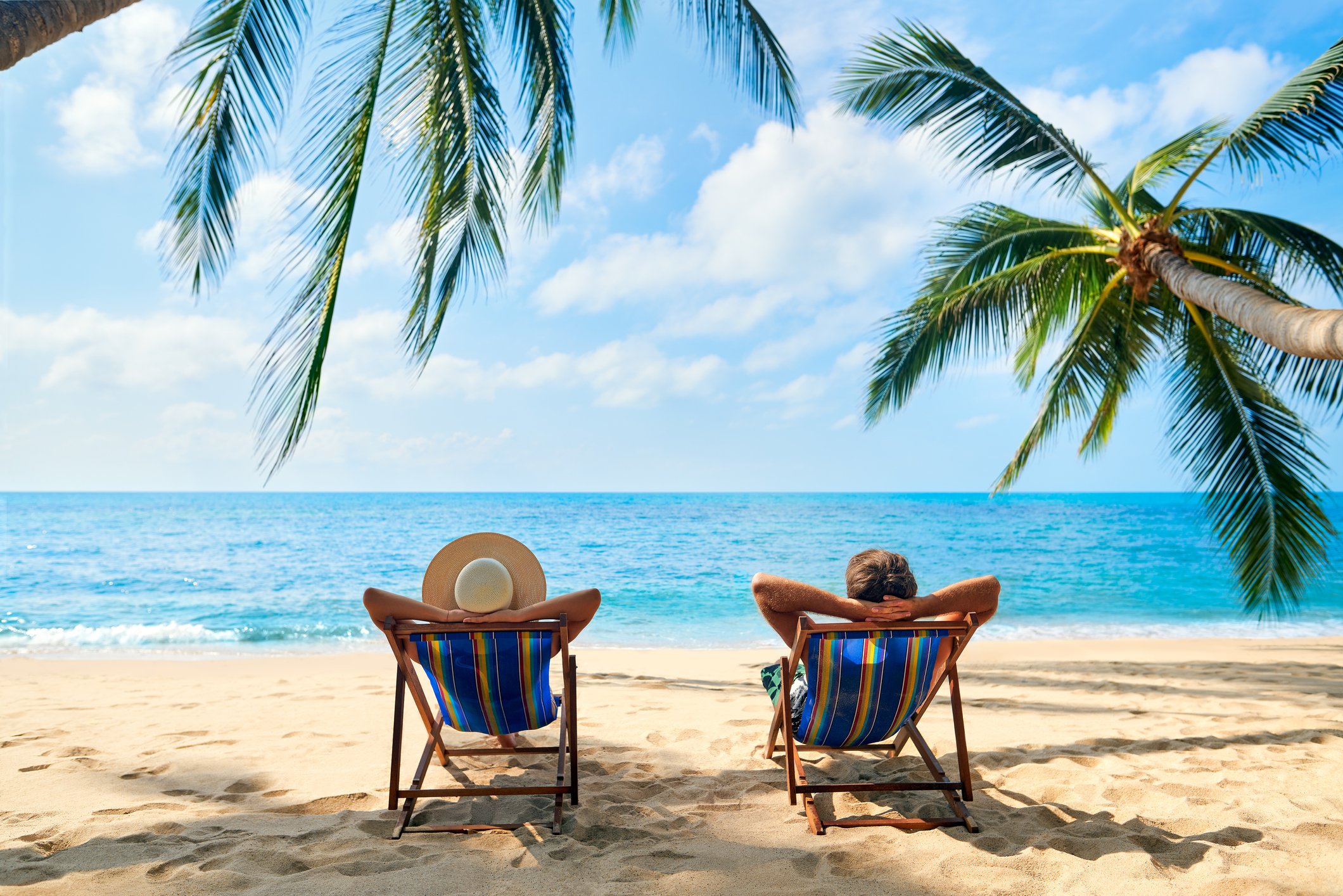 Two People In Chairs On The Beach