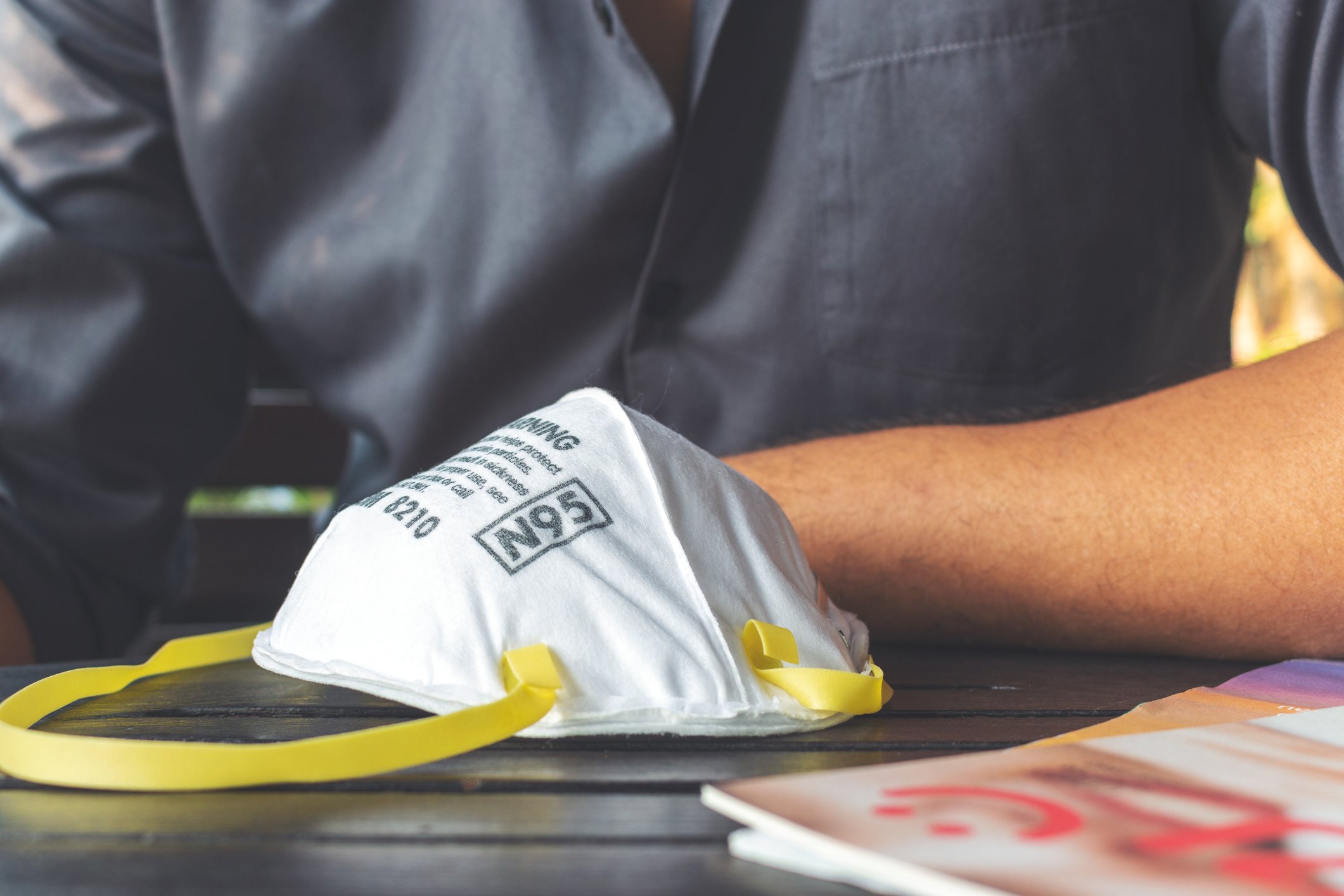 N95 respirator mask on table in front of healthcare worker