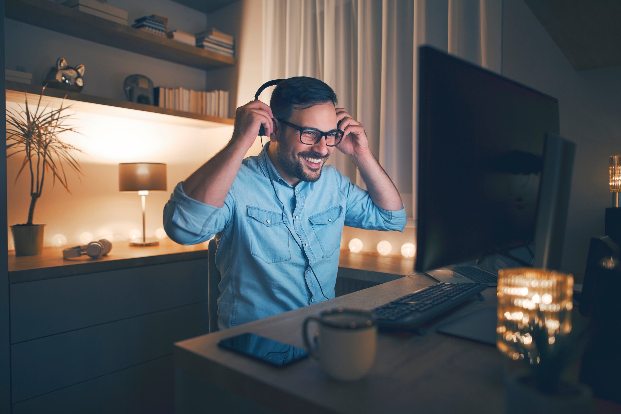 A man uses video conferencing software on a PC.