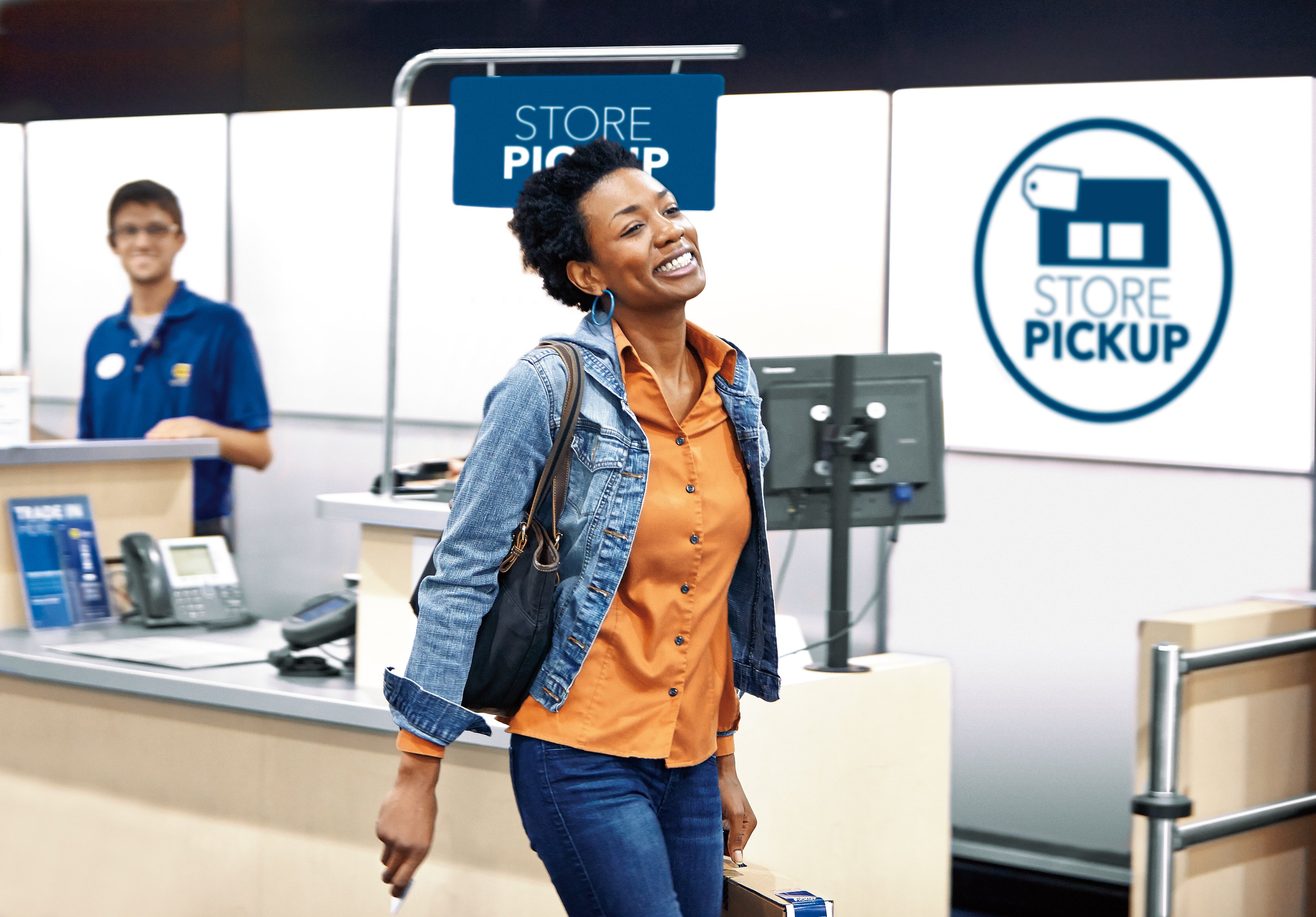A customer walking away from a store pickup register at a Best Buy