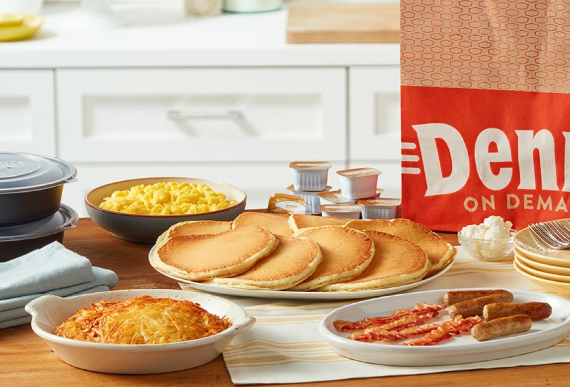 A Denny's shareable family pack of breakfast foods sitting on a table.