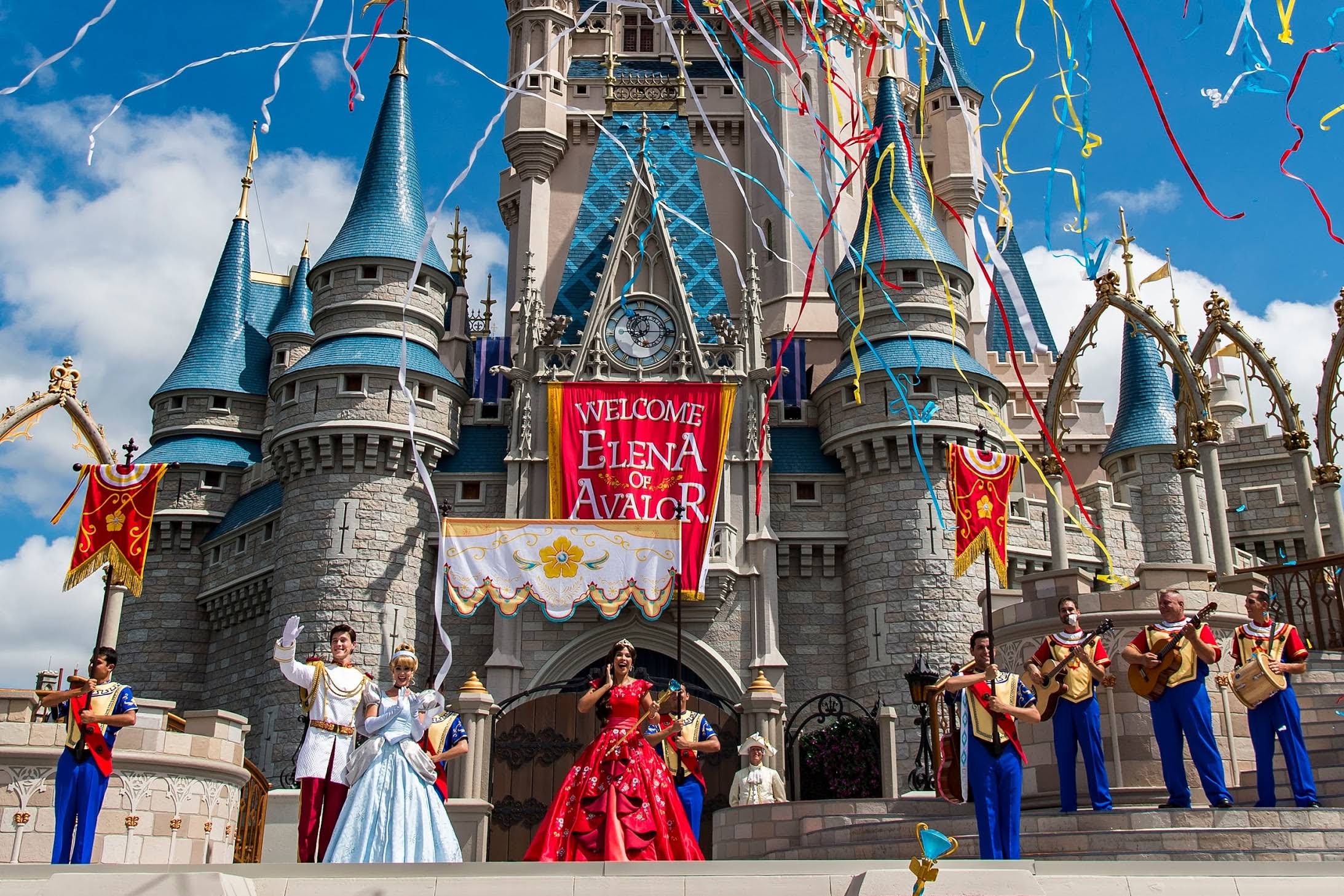 Magic Kingdom at Disney, with several characters in front and lots of streamers flying through the sky.