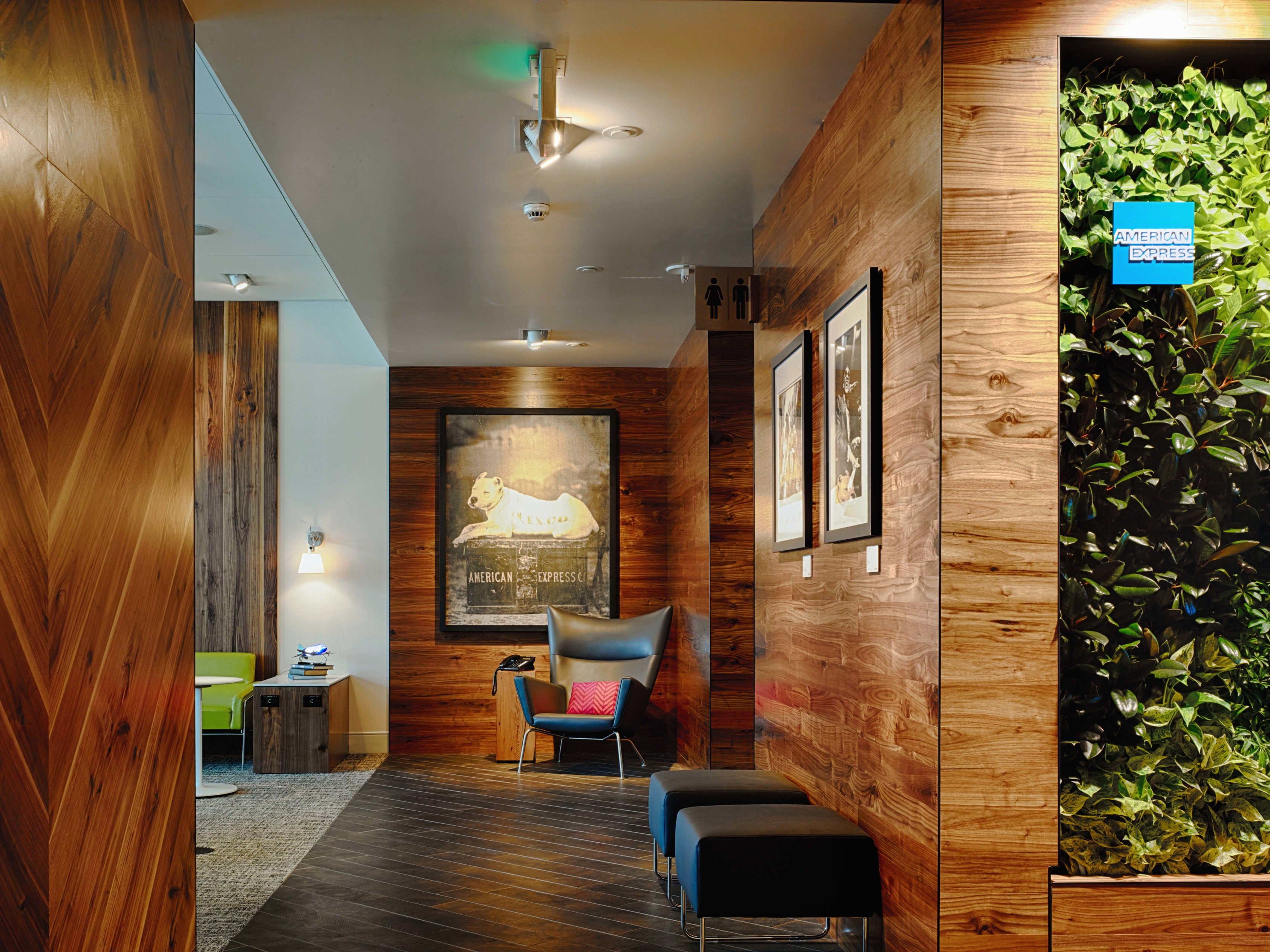 Airport lounge with American Express branding.