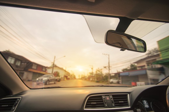 A view of a neighborhood from inside a car.