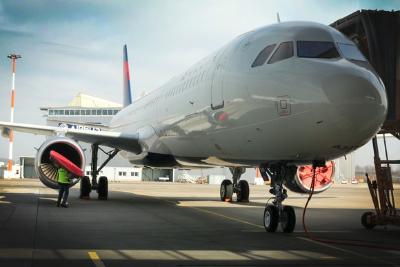 A Delta Airbus A321 at an airport terminal gate. 